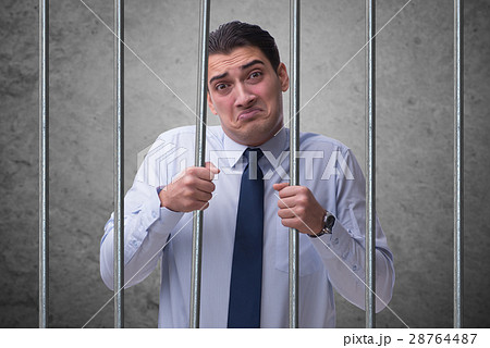 Young businessman behind the bars in prison 28764487