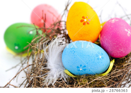 Colorful easter eggs in nest on a white background Colorful easter eggs in nest on a white background 28766363