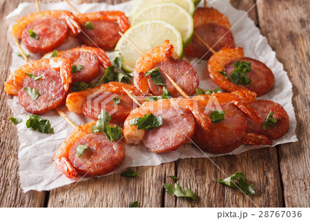 Delicious grilled shrimp with chorizo on skewers Delicious grilled shrimp with chorizo on skewers 28767036