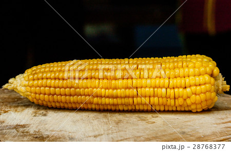 sweet corn with some ears partially husked 28768377