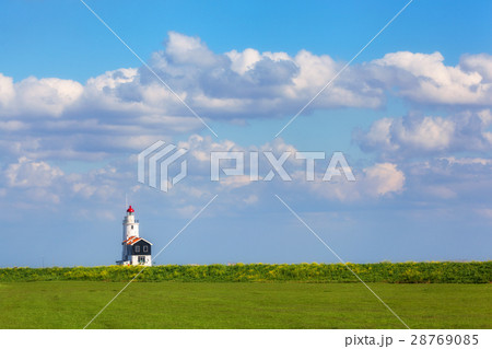 Lighthouse on the background of beautiful blue sky 28769085