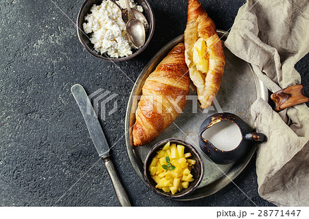 Breakfast with croissant and mango fruit 28771447