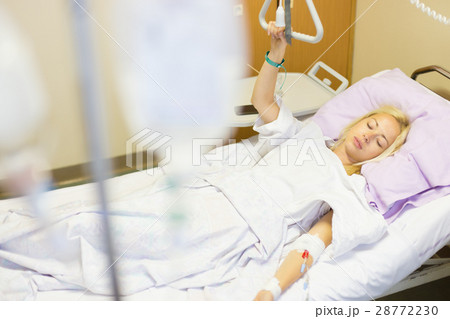 Bedridden female patient recovering after surgery Bedridden female patient recovering after surgery 28772230