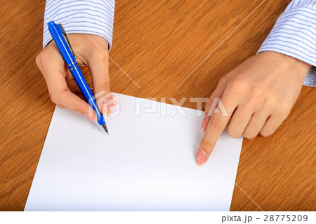 Female hand signing contract. 28775209