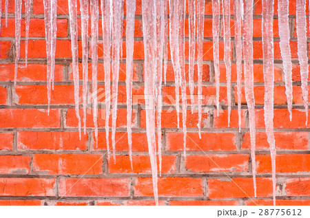 icicles on a background of red brick wall icicles on a background of red brick wall 28775612