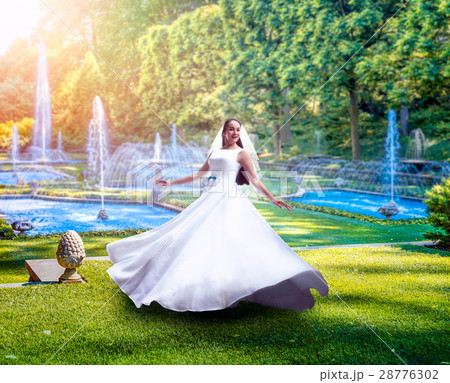 Young bride in green park with fountains Young bride in green park with fountains 28776302