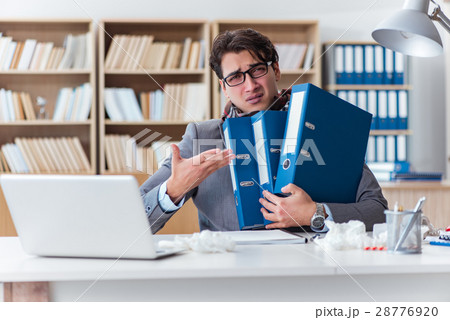 Sick businessman suffering from illness in the Sick businessman suffering from illness in the 28776920