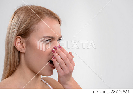 Young woman does not like her breath Young woman does not like her breath 28776921