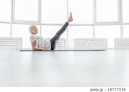 Healthy old lady exercising on mat 28777556