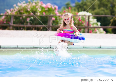 Child with toy ring in swimming pool Child with toy ring in swimming pool 28777715