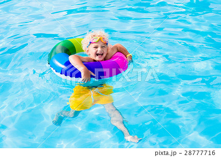 Child with toy ring in swimming pool Child with toy ring in swimming pool 28777716