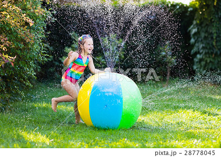 Little girl with toy ball garden sprinkler Little girl with toy ball garden sprinkler 28778045
