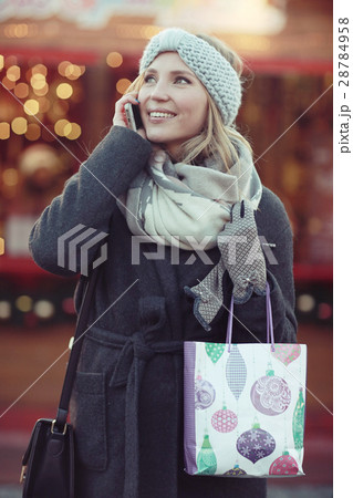 cheerful woman talking on the phone outside a city winter cheerful woman talking on the phone outside a city winter 28784958