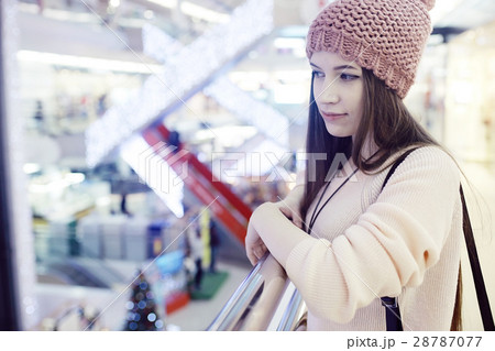 girl in a knitted hat walking in the mall 28787077