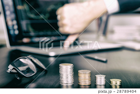 Coin money stack is going down as business man stock fail , thumb down Coin money stack is going down as business man stock fail , thumb down 28789404