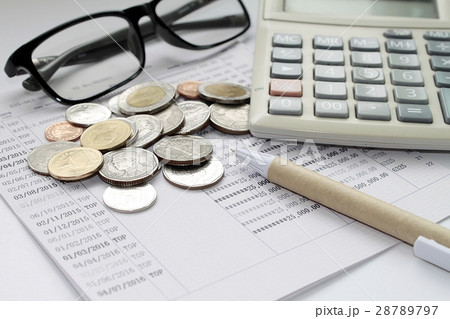 Coins, glasses, calculator and pen on passbook 28789797