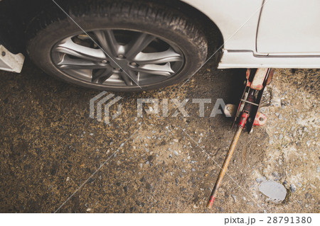Jacking up a car for change the wheel. Jacking up a car for change the wheel. 28791380