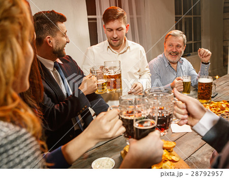 Group of friends enjoying evening drinks with beer 28792957