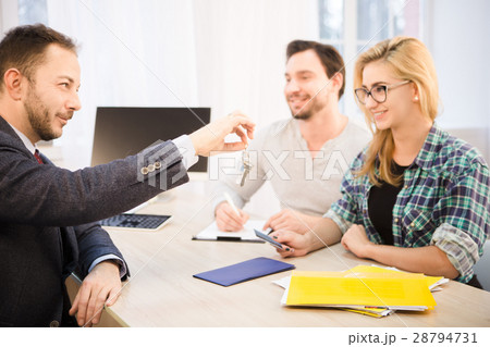 Manager giving key to couple Manager giving key to couple 28794731