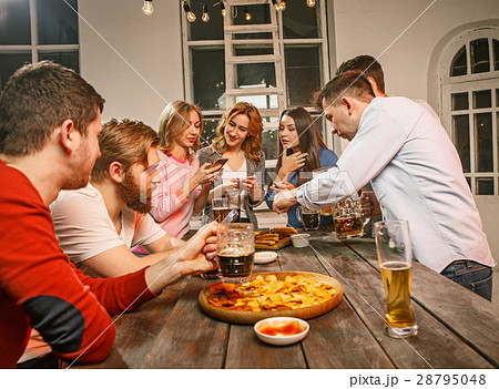Group of friends enjoying evening drinks with beer Group of friends enjoying evening drinks with beer 28795048