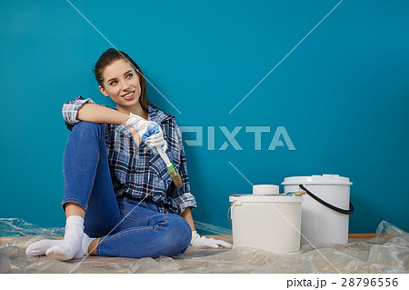 Happy beautiful young woman doing wall painting Happy beautiful young woman doing wall painting 28796556