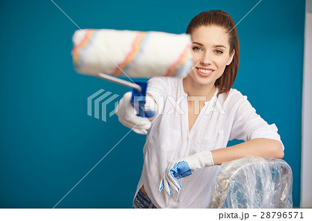 bright picture of lovely housewife painting  home 28796571
