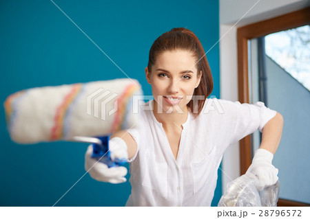 bright picture of lovely housewife painting  home 28796572