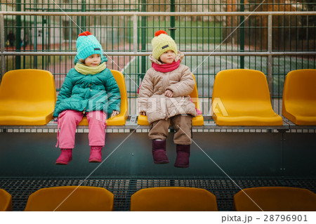 Two girls sit on a tribune 28796901