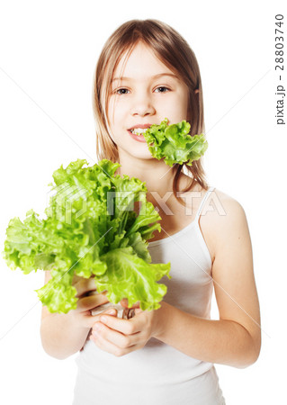 Girl eating lettuce. Portrait of beautiful smiling 28803740