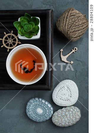 Cup of black tea and crocheted pebbles Cup of black tea and crocheted pebbles 28804109