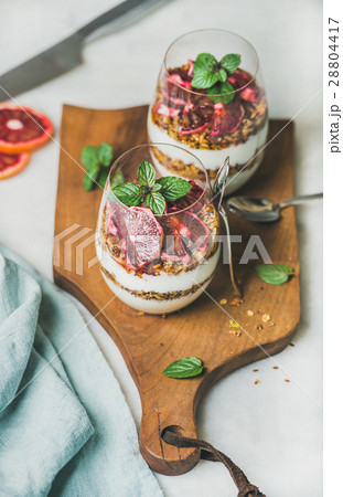 Healthy breakfast with yogurt, granola, orange Healthy breakfast with yogurt, granola, orange 28804417