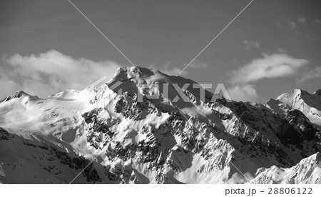 Black and white view on snowy mountains at sun day 28806122