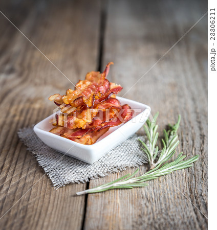 Fried bacon strips with fresh rosemary 28806211