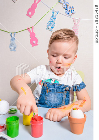 smilling boy making bunny for easter smilling boy making bunny for easter 28816429