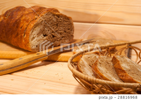 sliced ​​wheat - rye bread on a wooden board  28816968