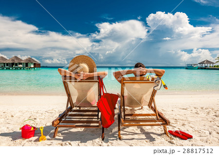 Couple in loungers on beach at Maldives 28817512