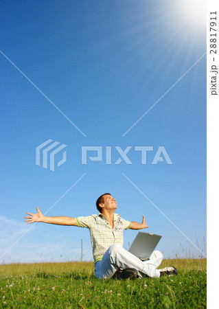 Student with laptop on green meadow Student with laptop on green meadow 28817911