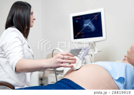 Female doctor using ultrasound and screening Female doctor using ultrasound and screening 28819919