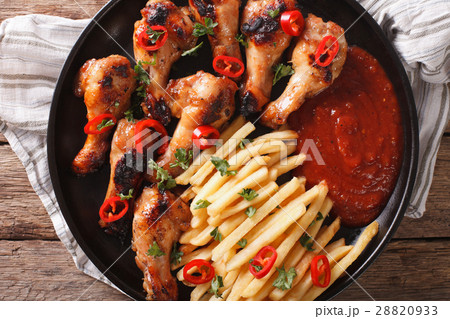 Grilled chicken wings with french fries 28820933
