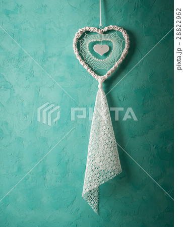 White dream catcher on green wall White dream catcher on green wall 28822962