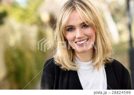 Beautiful young blonde woman in urban background Beautiful young blonde woman in urban background 28824599
