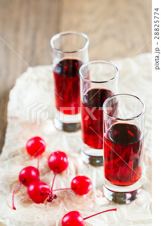 Glasses of cherry brandy with cocktail cherries 28825774