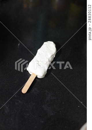 Coconut popsicles on black background Coconut popsicles on black background 28830112