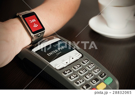 Man making payment through smartwatch via NFC 28832065