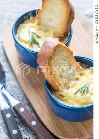Bowls of onion soup on the wooden board Bowls of onion soup on the wooden board 28832511