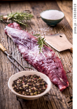 Beef.Raw beef tenderloin steak on a cutting board. 28838019