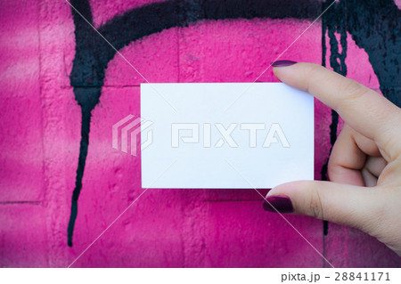 Female hand holding blank white business card. Female hand holding blank white business card. 28841171