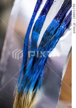 Man in gloves is dying long blue hair colorfull 28841790
