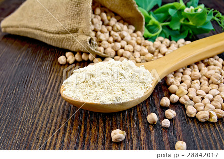 Flour chickpeas in spoon on board 28842017