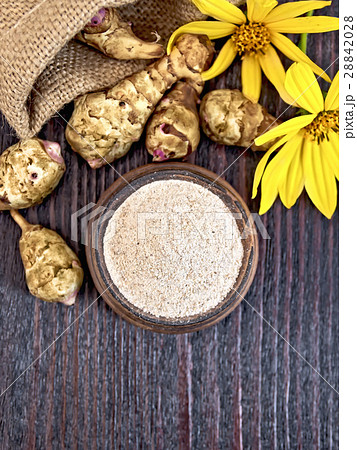 Flour of Jerusalem artichoke in clay bowl on top Flour of Jerusalem artichoke in clay bowl on top 28842028